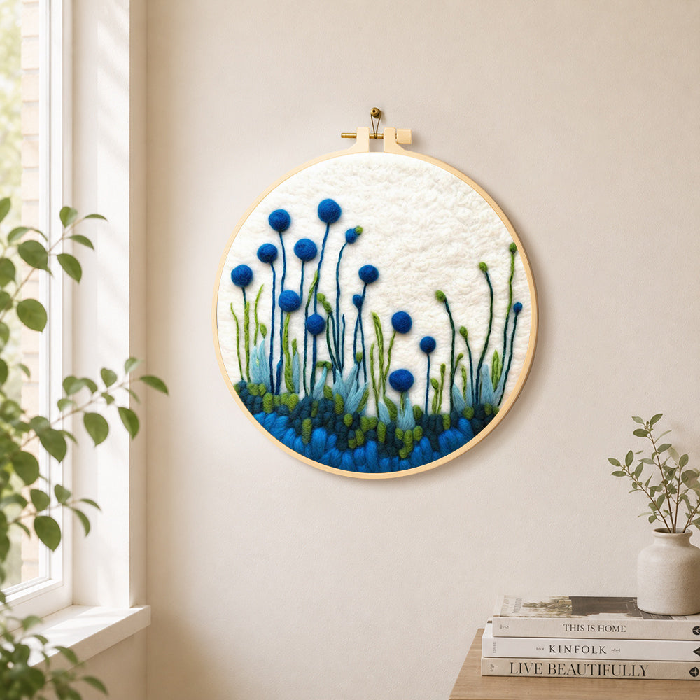 Tall blue wildflowers on white needle felt wall art displayed in a bright home interior