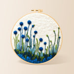 Tall blue wildflowers on white needle felting kit for beginners with a round wooden frame