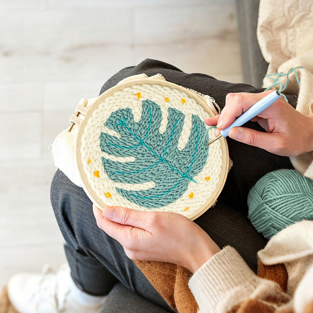 Creating handmade teal monstera leaf with stars punch needle artwork