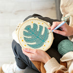 Creating handmade teal monstera leaf with stars punch needle artwork