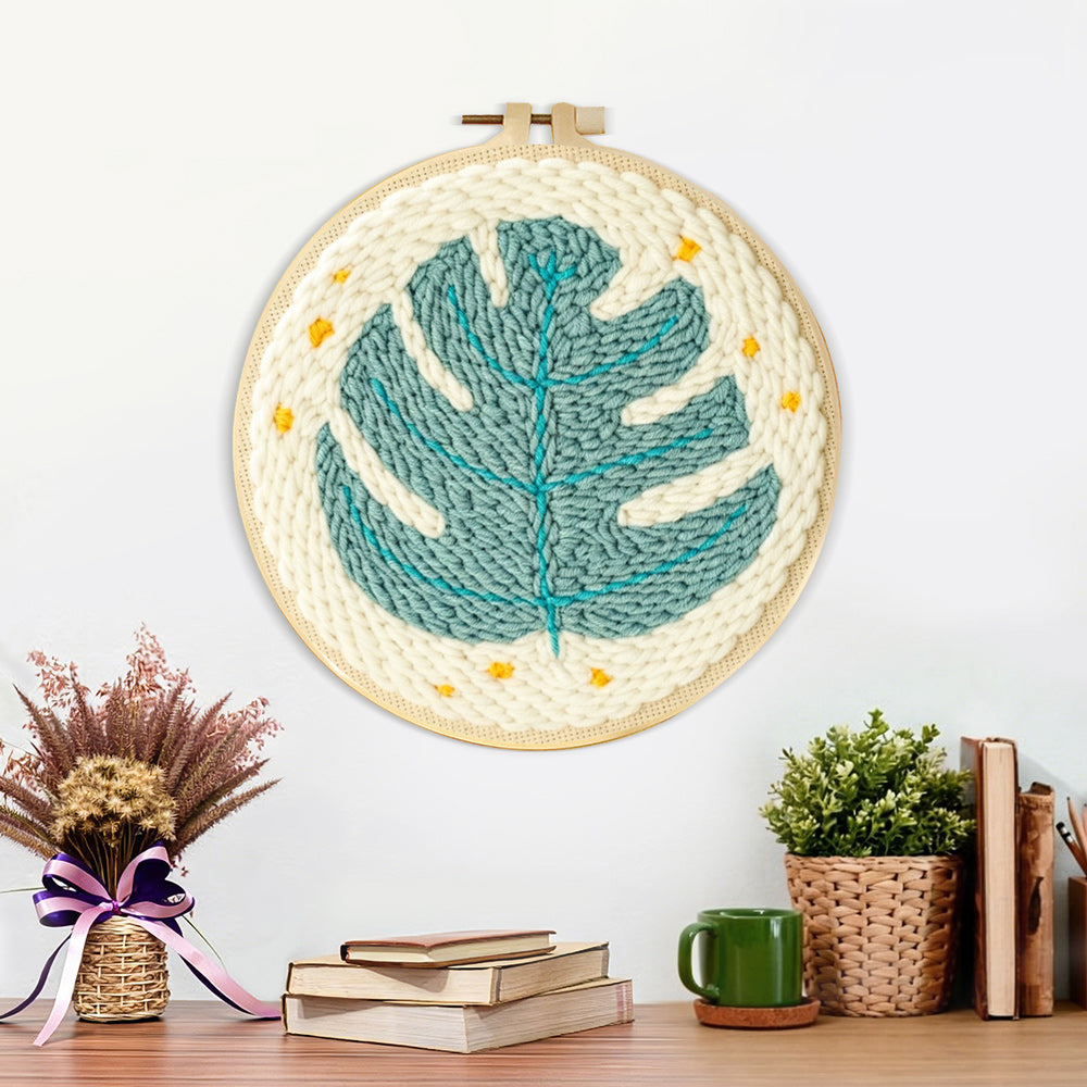 Finished teal monstera leaf with stars artwork displayed on a wall