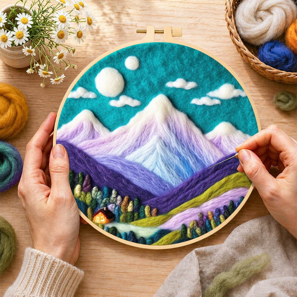 Creating the teal sky and purple mountains wool painting by hand with a felting needle