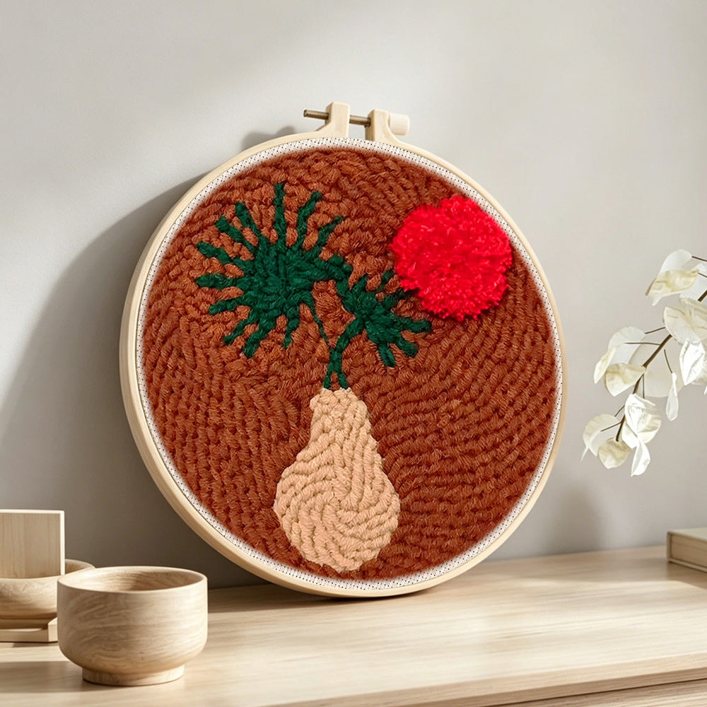 Terracotta sunset botanical punch needle artwork displayed on a table