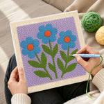 Creating handmade three blue flowers punch needle artwork