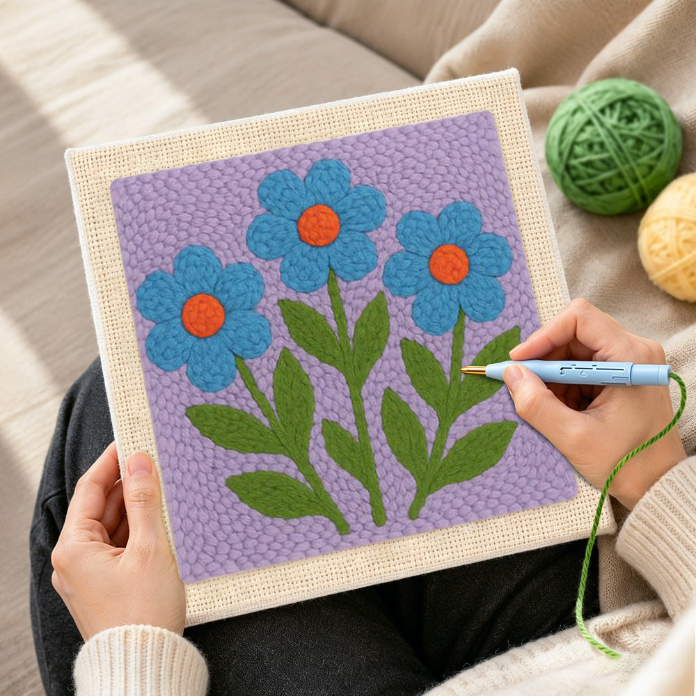 Creating handmade three blue flowers punch needle artwork