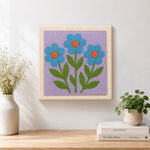 Finished three blue flowers artwork displayed on a wall