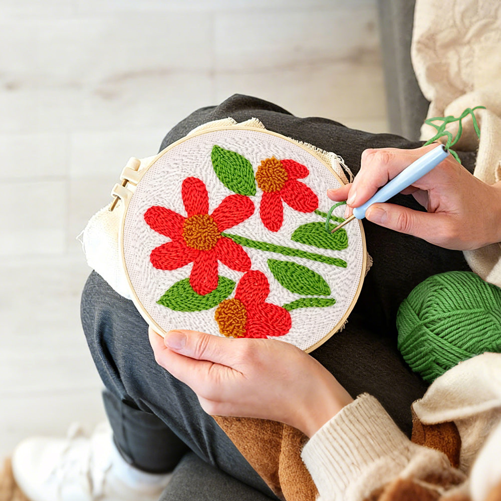 Creating handmade three red flowers with green leaves punch needle artwork