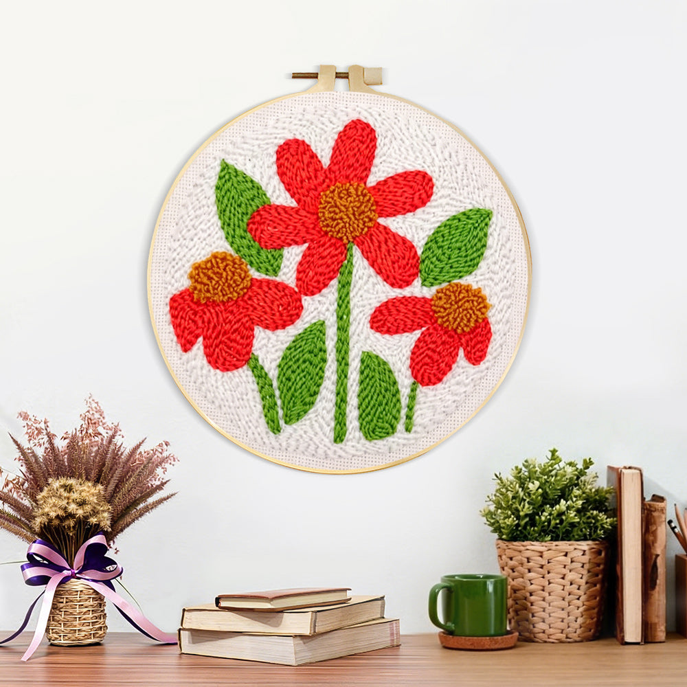 Finished three red flowers with green leaves artwork displayed on a wall