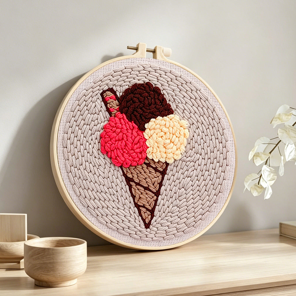 Three-scoop ice cream cone punch needle artwork displayed on a table