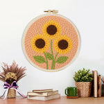 Finished three sunflowers on peachy pink artwork displayed on a wall