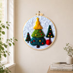 Three tiered christmas trees needle felt wall art displayed in a bright home interior