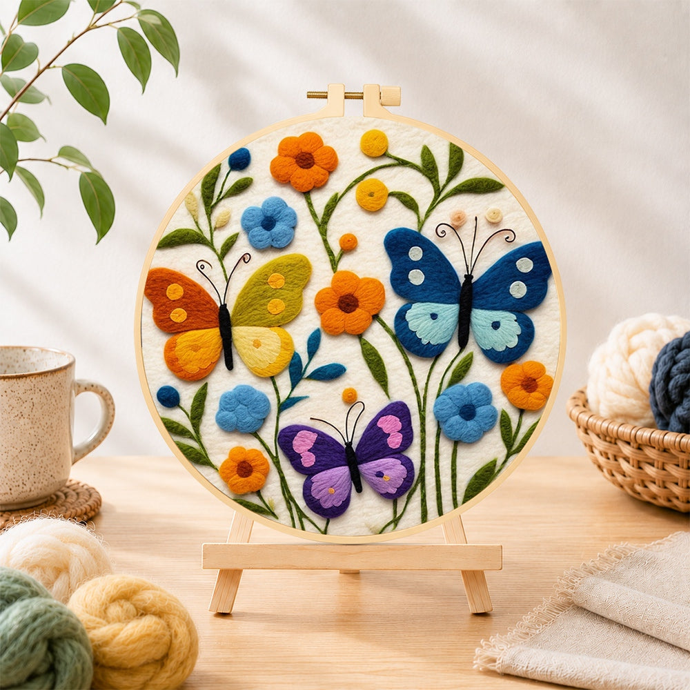 Finished three whimsical butterflies among flowers needle felting displayed on a wooden easel