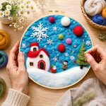Creating the tiny scene with red house and snowflake wool painting by hand with a felting needle