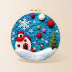 Tiny scene with red house and snowflake needle felting kit for beginners with a round wooden frame