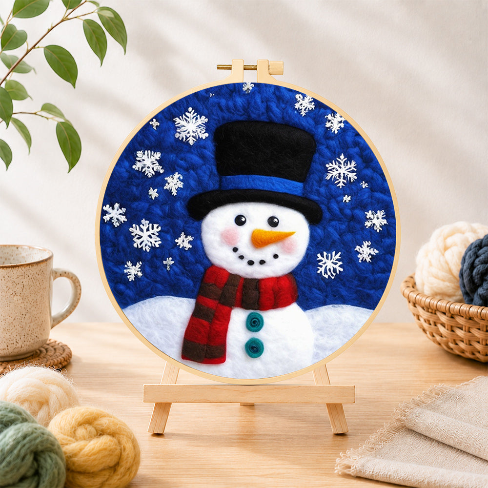 Finished top hat snowman with falling snowflakes needle felting displayed on a wooden easel