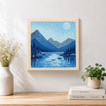 Finished tranquil blue fjord and boats artwork displayed on a wall