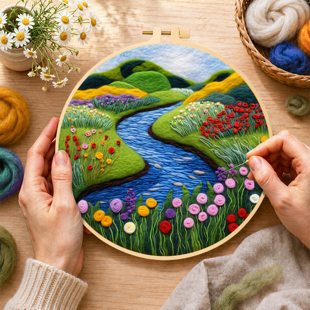 Creating the tranquil river, wildflowers and meadow wool painting by hand with a felting needle