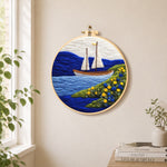 Tranquil white sailboat and floral shoreline needle felt wall art displayed in a bright home interior