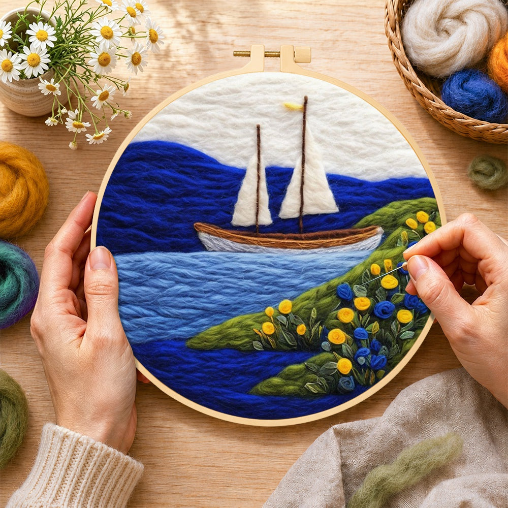 Creating the tranquil white sailboat and floral shoreline wool painting by hand with a felting needle