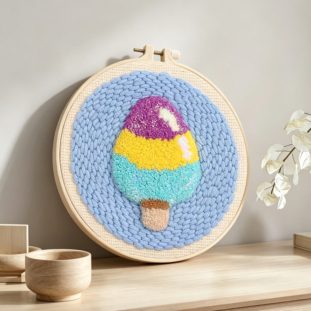 Tri-colour ice cream punch needle artwork displayed on a table