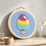 Tri-colour ice cream punch needle artwork displayed on a table