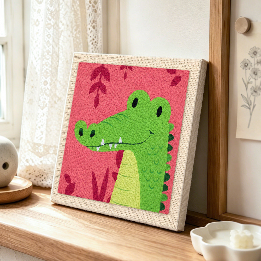 Tropical green crocodile punch needle artwork displayed on a table