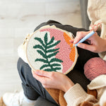 Creating handmade tropical leaf and sunset tones punch needle artwork