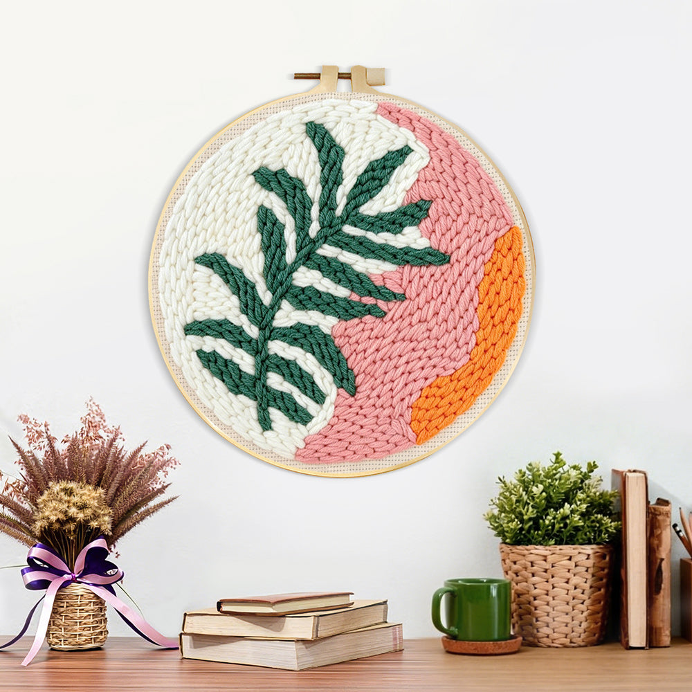 Finished tropical leaf and sunset tones artwork displayed on a wall