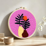Tropical leaf at sunset punch needle artwork displayed on a table