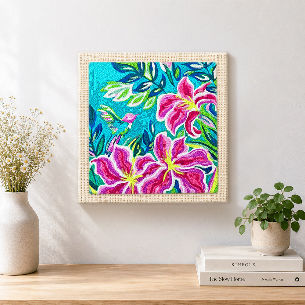 Finished tropical lily flowers and hummingbird artwork displayed on a wall