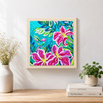 Finished tropical lily flowers and hummingbird artwork displayed on a wall