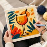 Creating handmade tropical orange cocktail punch needle artwork