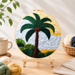 Finished tropical palm tree needle felting displayed on a wooden easel