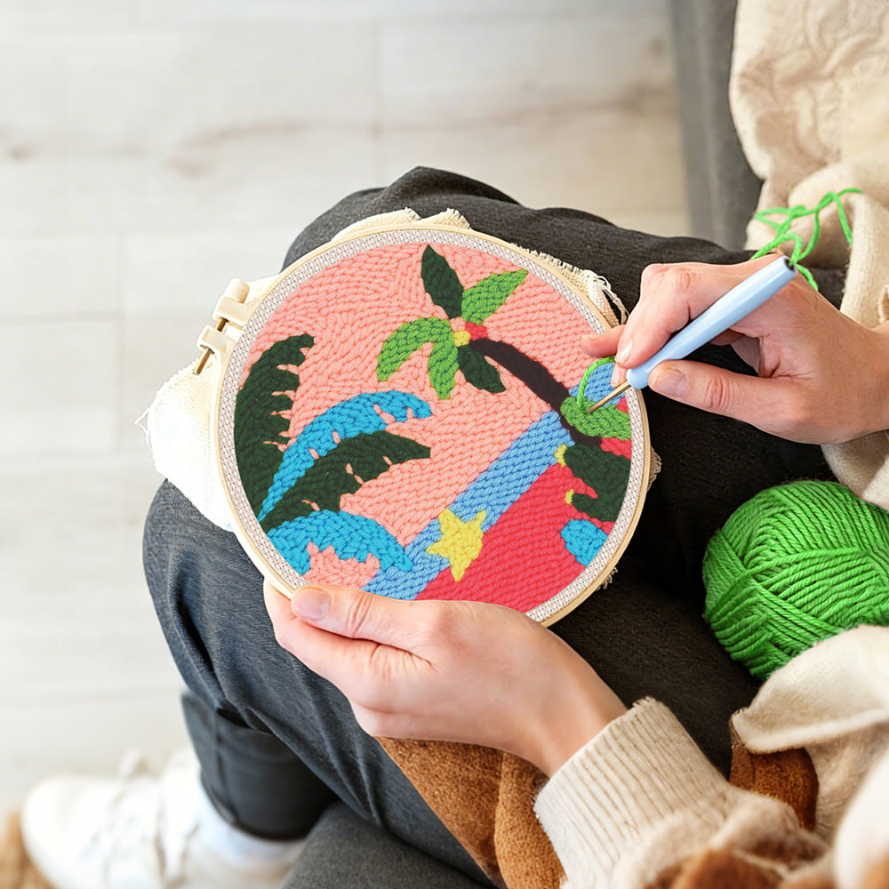 Creating handmade tropical palm tree sunset punch needle artwork