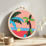 Tropical palm tree sunset punch needle artwork displayed on a table