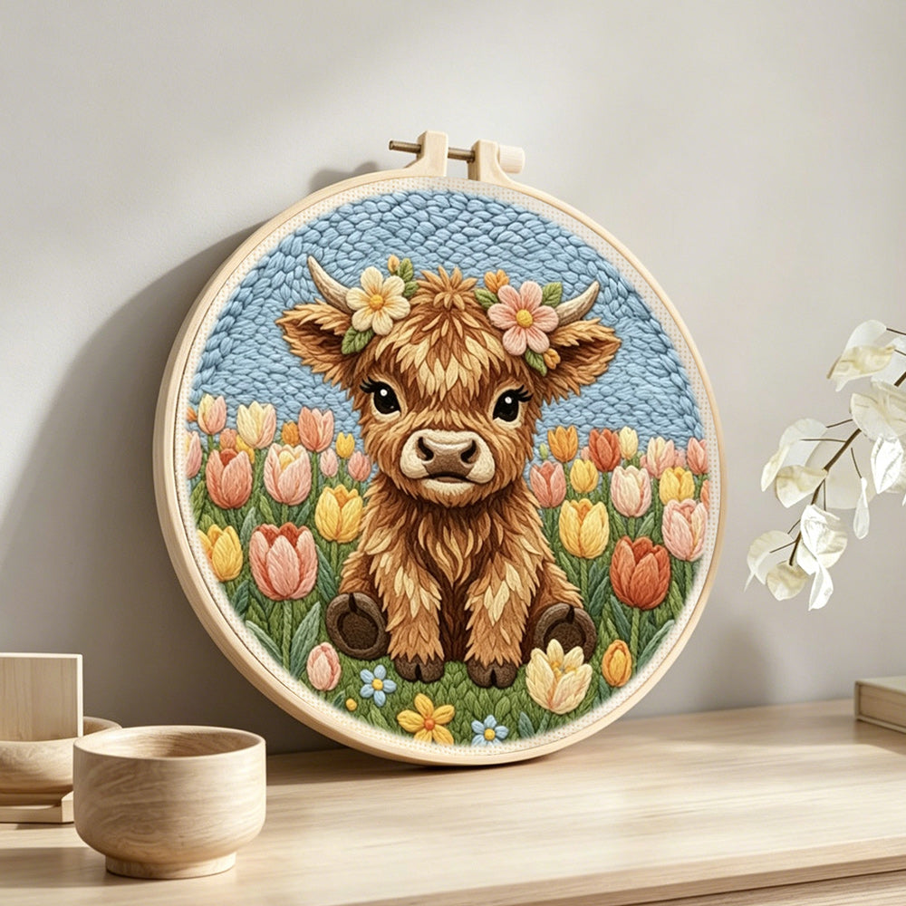 Tulip flower highland cow punch needle artwork displayed on a table