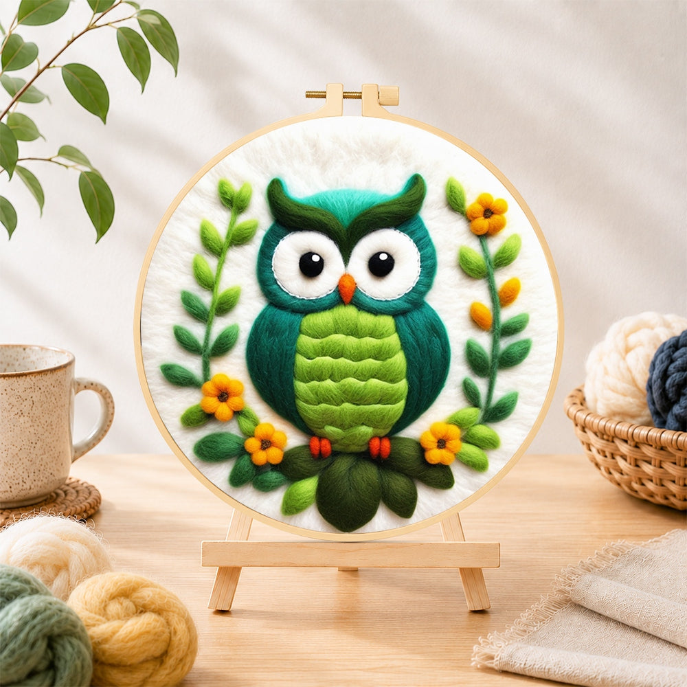 Finished turquoise owl needle felting displayed on a wooden easel