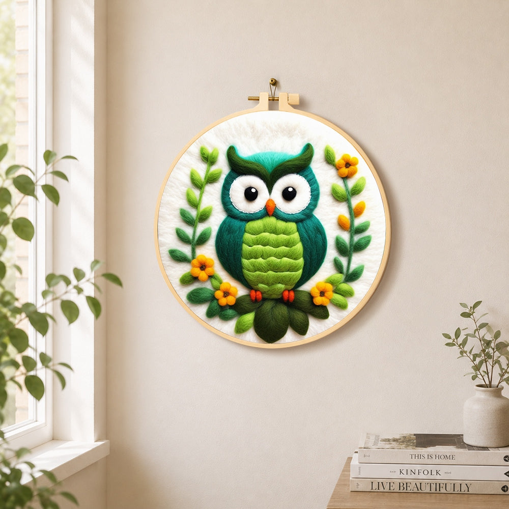 Turquoise owl needle felt wall art displayed in a bright home interior