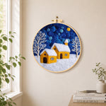 Twin yellow cottages under the starry sky needle felt wall art displayed in a bright home interior
