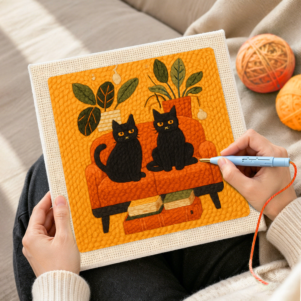 Creating handmade two black cats on a sofa punch needle artwork