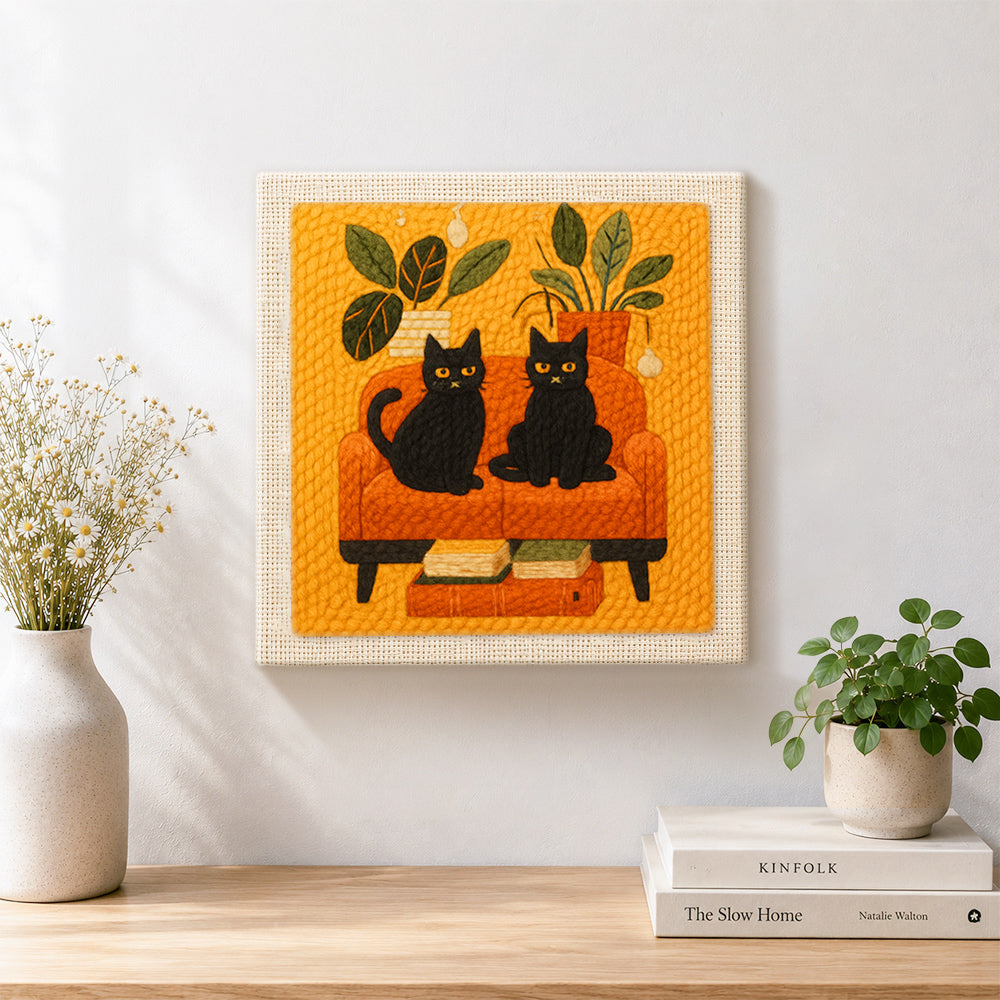 Finished two black cats on a sofa artwork displayed on a wall