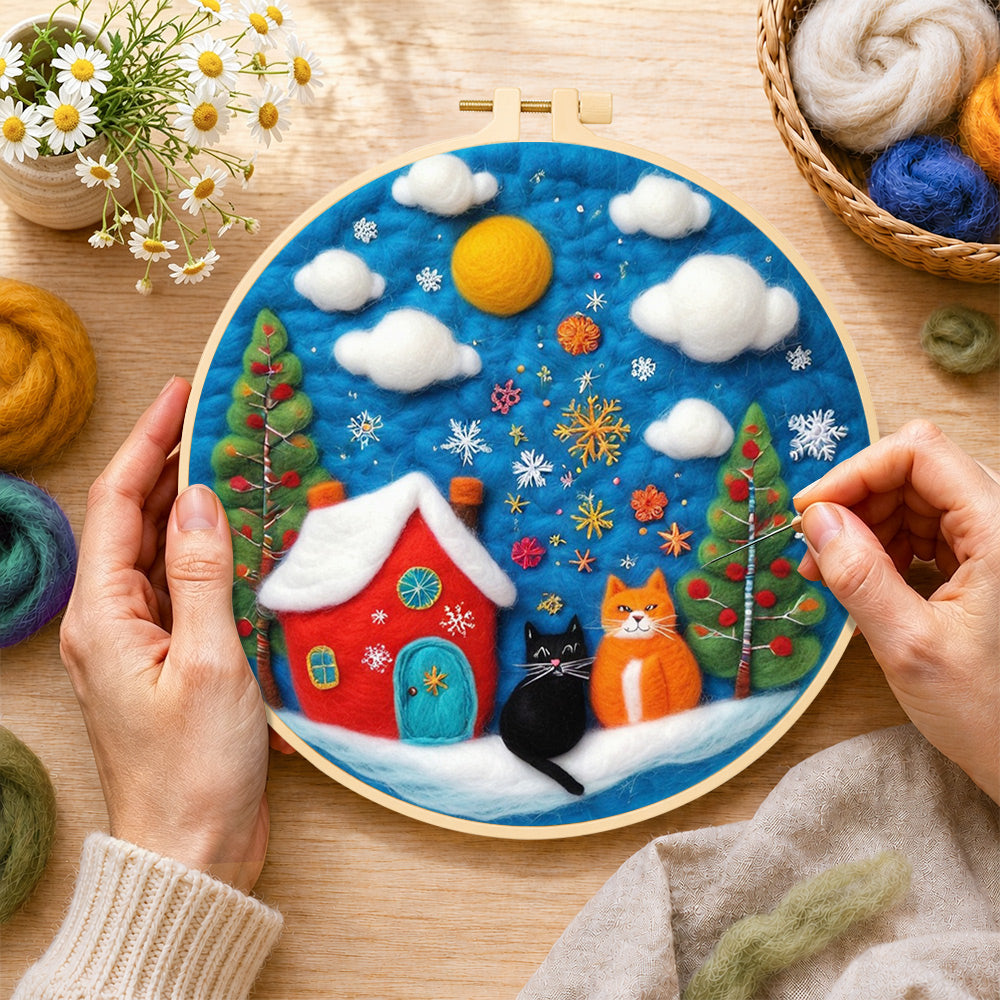 Creating the two christmas cats with red house wool painting by hand with a felting needle