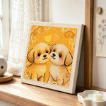 Two cuddly puppies punch needle artwork displayed on a table