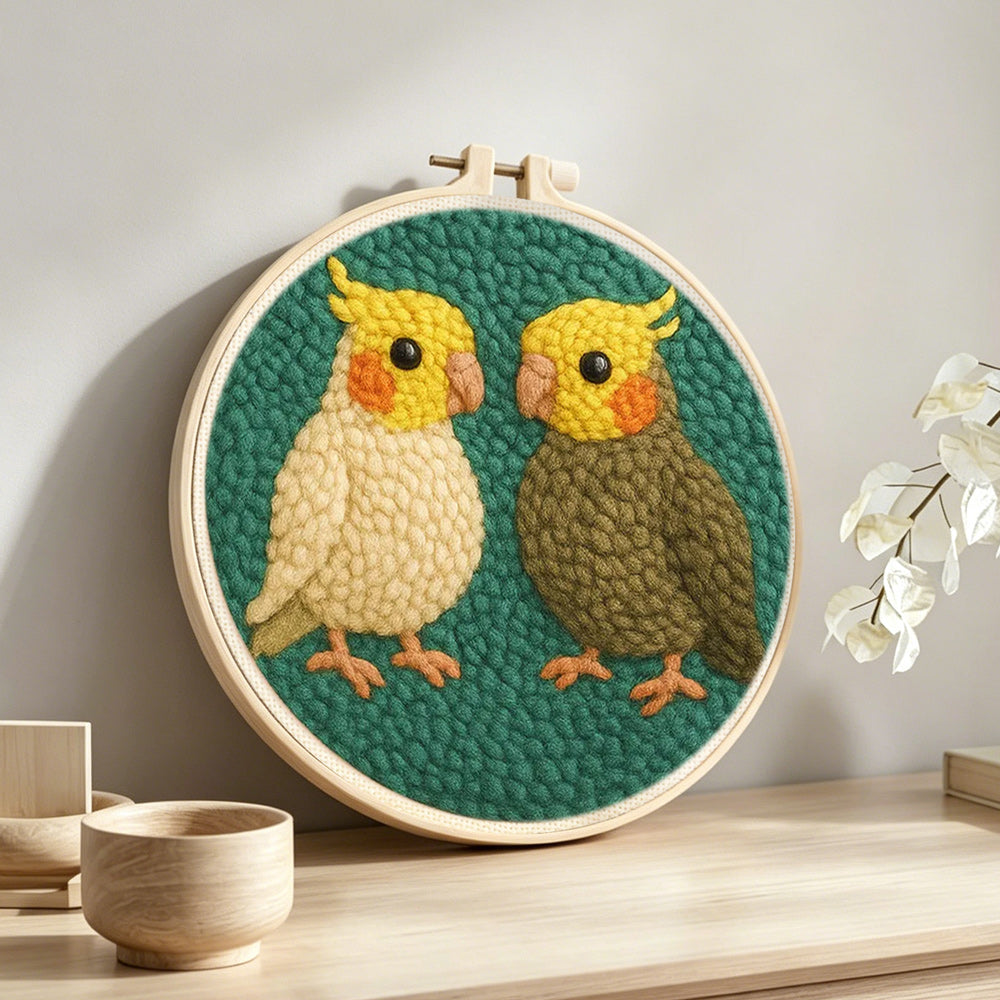Two cute parrots punch needle artwork displayed on a table