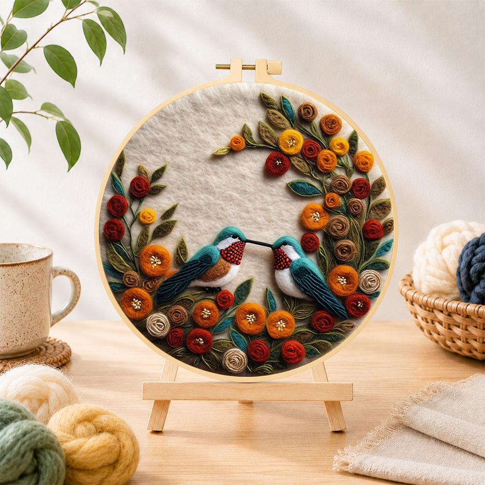Finished two hummingbirds with romantic floral wreath needle felting displayed on a wooden easel