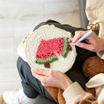 Creating handmade two slices of watermelon punch needle artwork