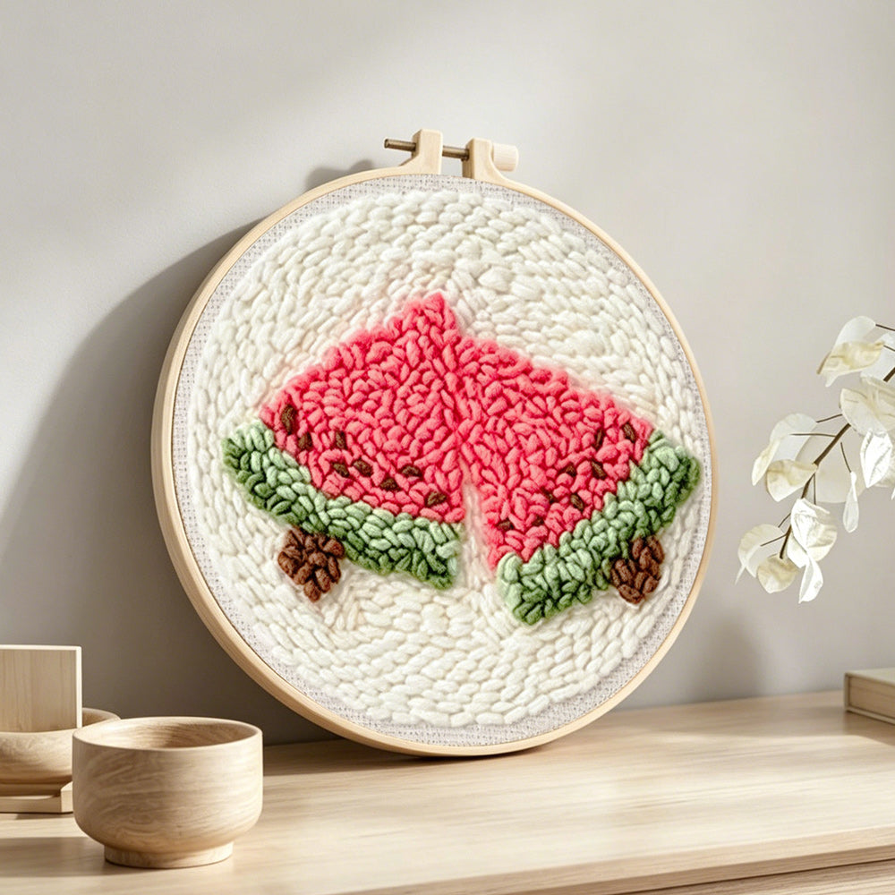 Two slices of watermelon punch needle artwork displayed on a table