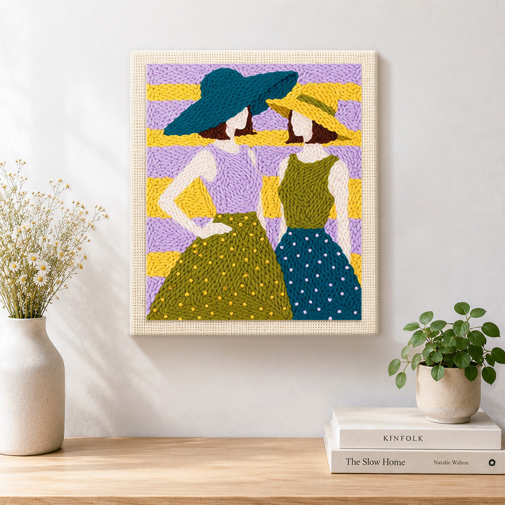 Finished two women in sun hats artwork displayed on a wall