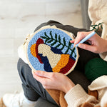 Creating handmade vibrant botanical lady punch needle artwork
