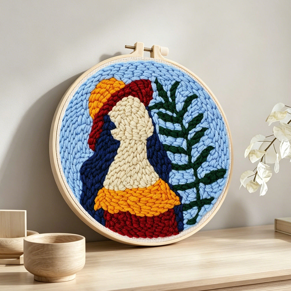 Vibrant botanical lady punch needle artwork displayed on a table